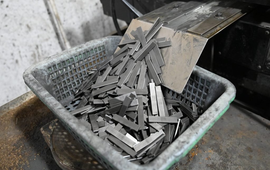 The same sintered neodymium blocks after chamfering in a drum chamfering machine