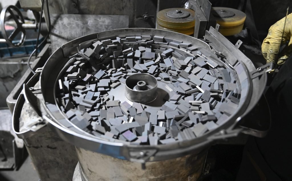 Grinding machine running a batch of sintered neodymium magnet parts