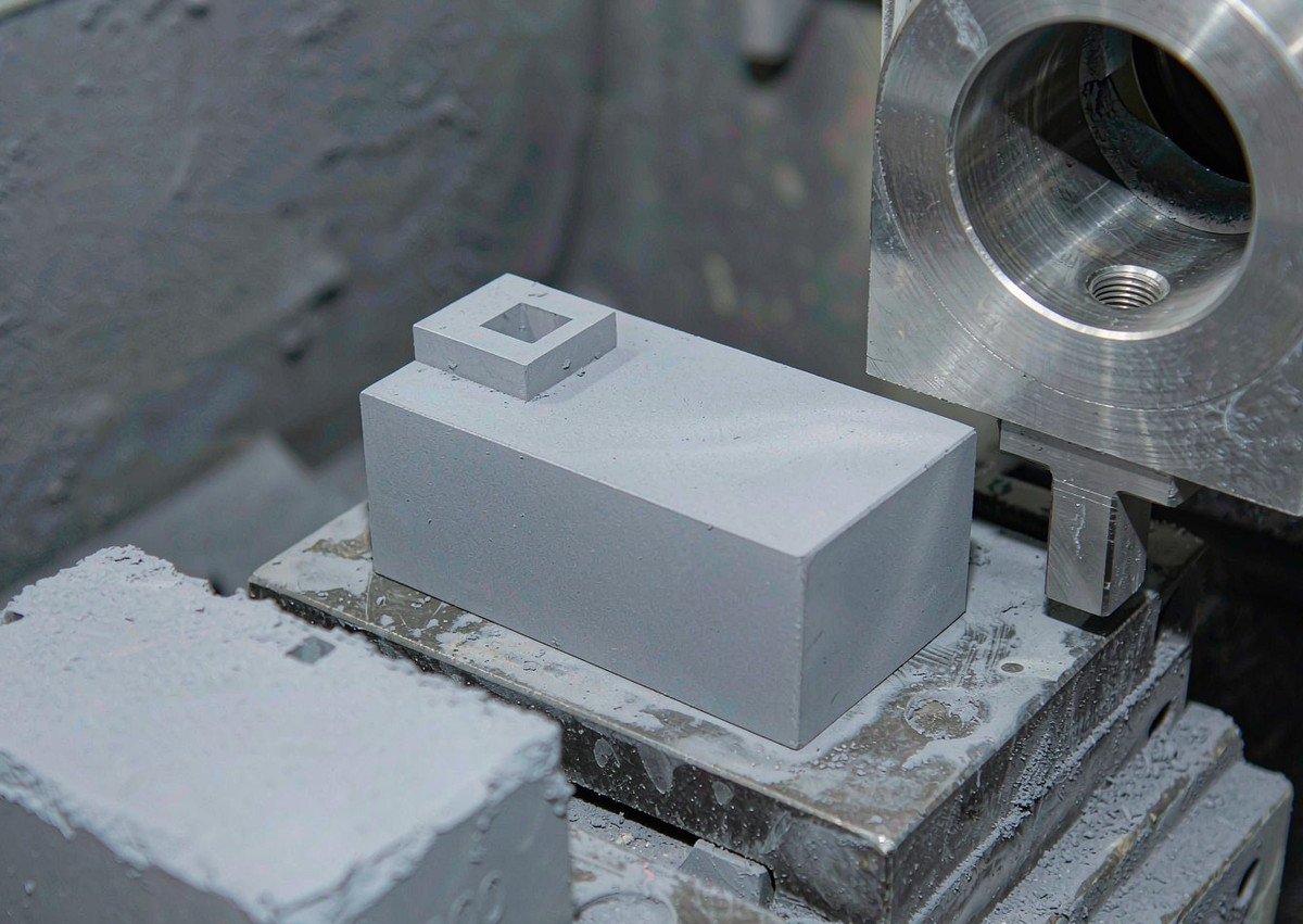 Manufacturing process: a sintered neodymium block held in a grinding fixture